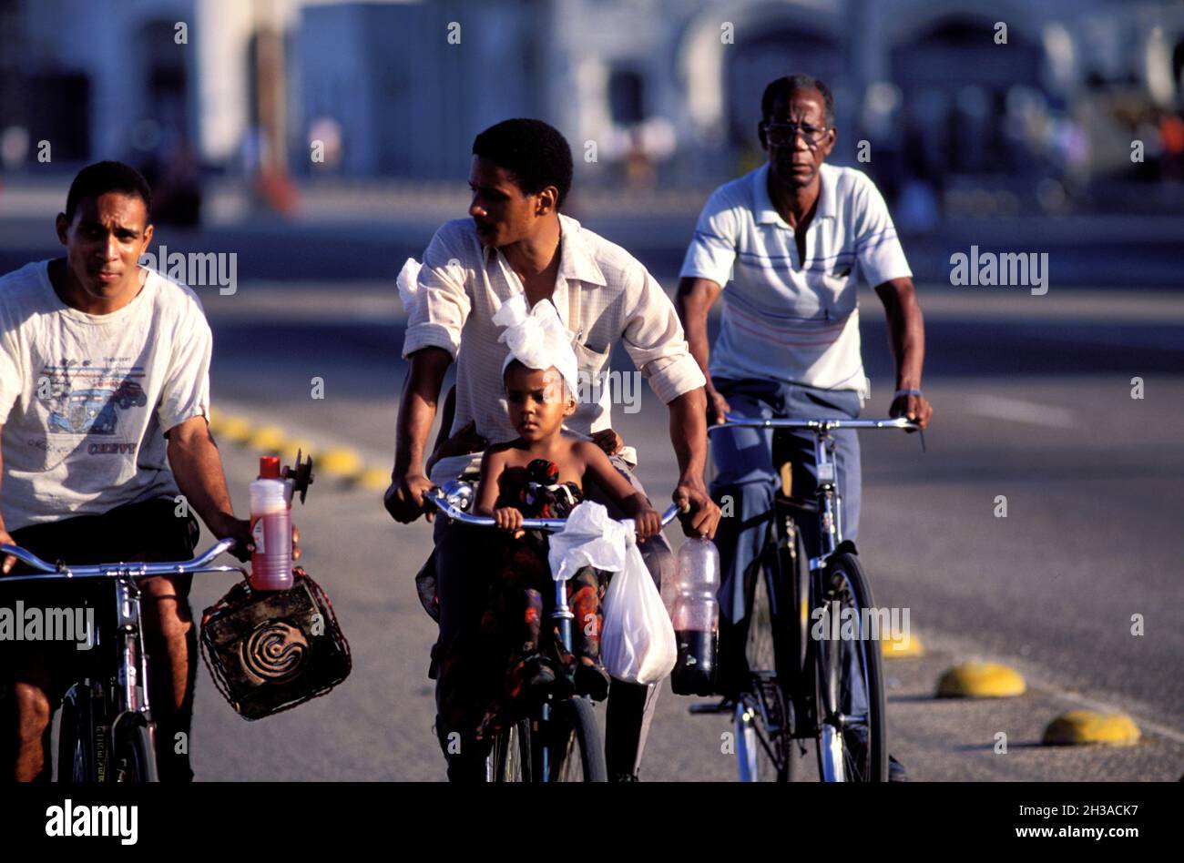 CUBA, HAVANA, CUBANS BY BYCICLES ON MALECON BOULEVARD (SEASIDE) Stock Photo