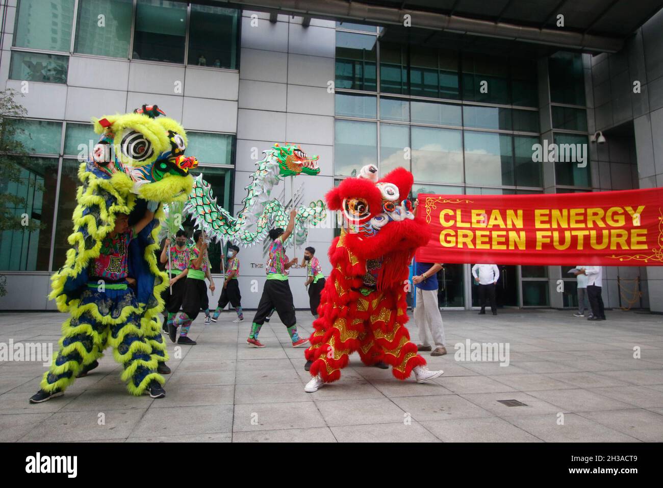 Metro Manila, Philippines. 27th October 2021. Climate activists held a dragon & lion dance at the Chinese Embassy in Makati, to rally for Asian-led leadership ahead of the United Nations Climate Conference in Glasgow, Scotland. Stock Photo