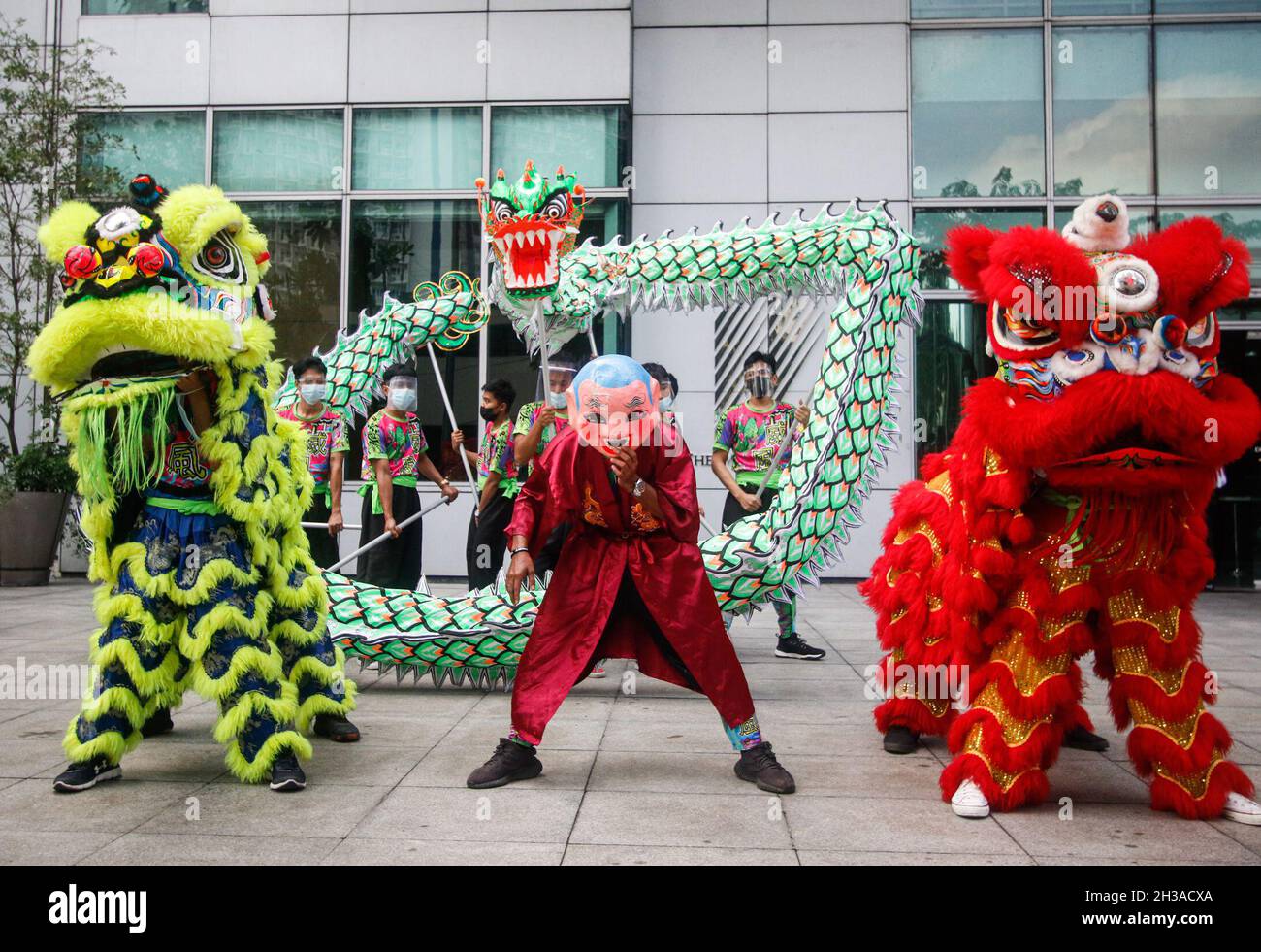 Metro Manila, Philippines. 27th October 2021. Climate activists held a dragon & lion dance at the Chinese Embassy in Makati, to rally for Asian-led leadership ahead of the United Nations Climate Conference in Glasgow, Scotland. Stock Photo