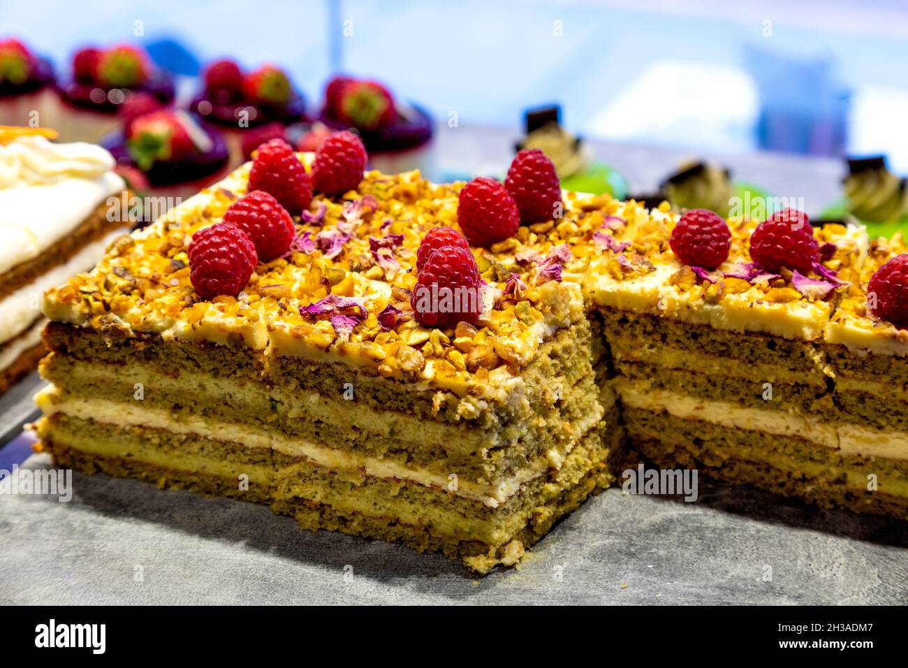 Delicious cake topped with raspberries at EL&N Cafe Brompton Road, London, UK Stock Photo