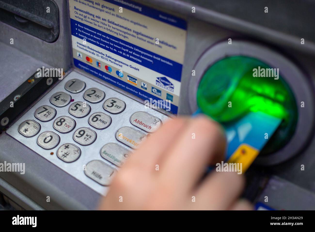ILLUSTRATION - 29 August 2021, Berlin: A bank customer inserts her ...