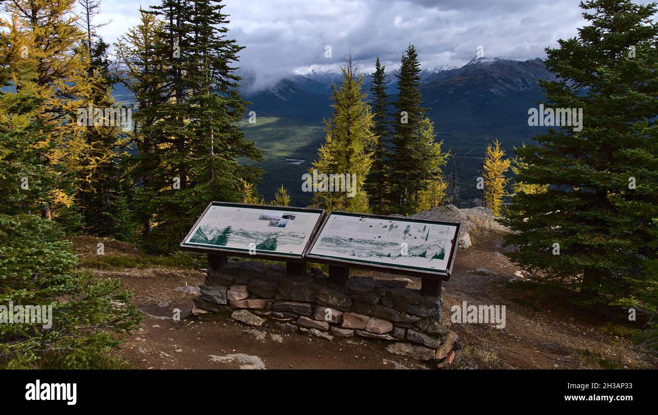 View of information board on the top of Little Beehive mountain in Banff National Park, Rocky Mountains, Canada in autumn season with colorful trees. Stock Photo