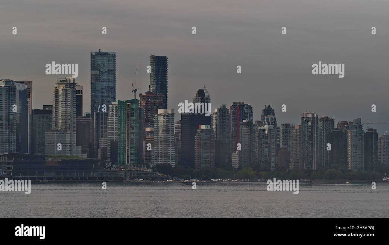 Idyllic view of Vancouver skyline in the morning with dizzy air and high-rise buildings with glass facades on cloudy day in autumn. Stock Photo