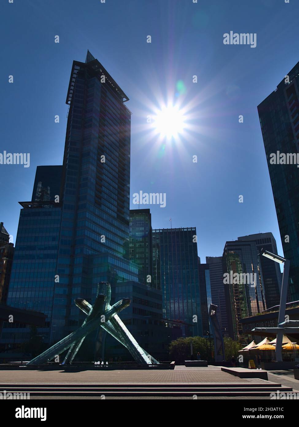 Beautiful view of Jack Poole Plaza in Vancouver downtown with the cauldron of the 2010 Olympic Winter Games and bright sun shining between skycrapers. Stock Photo