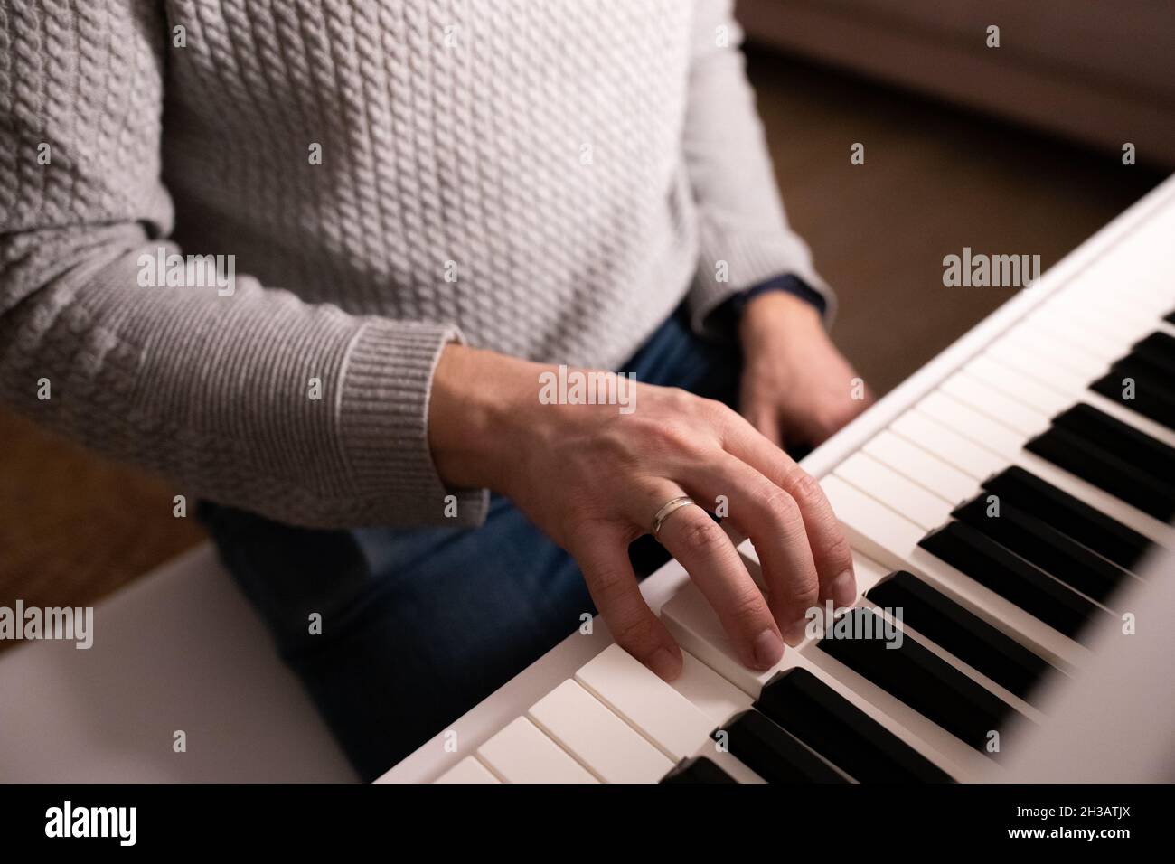 Learning to play the piano. A man plays an instrument. Piano keys ...