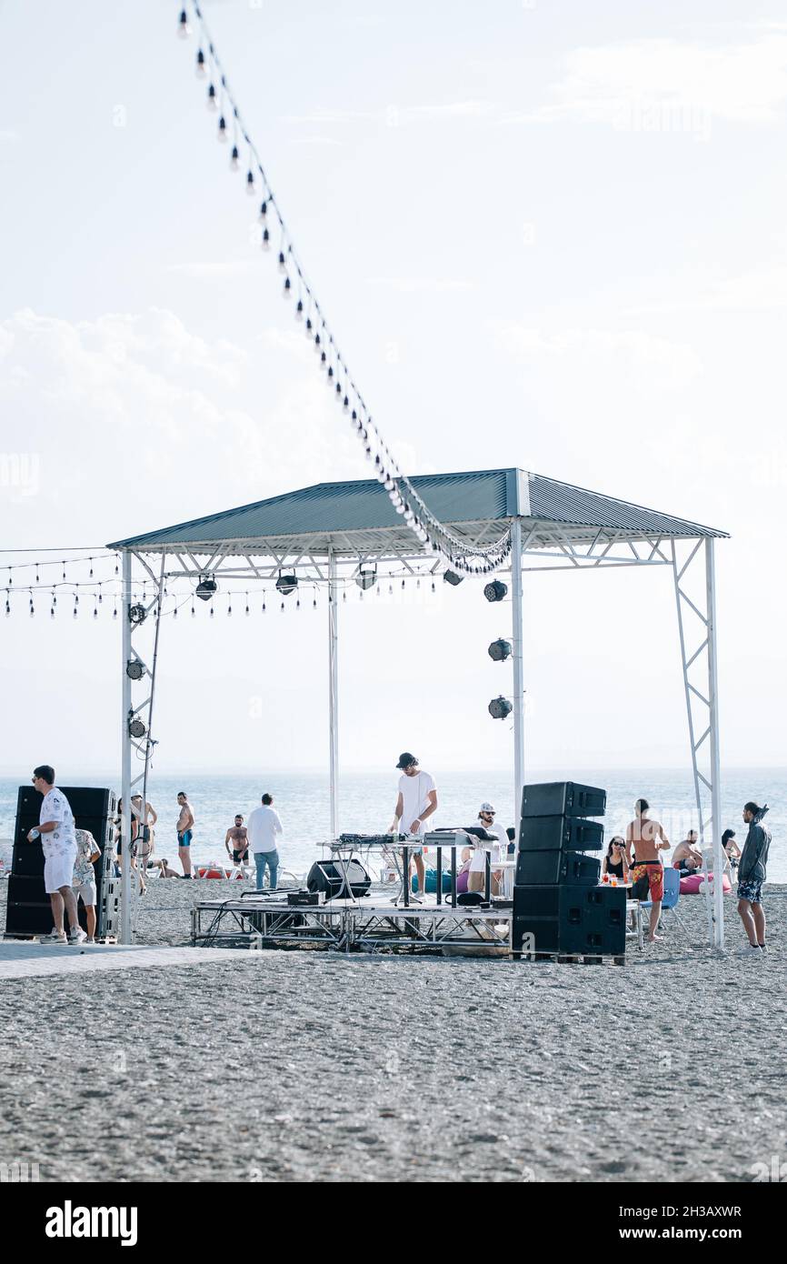 SEVA, ARMENIA - Sep 03, 2021: A group of young people enjoying the beach party on the shore of Lake Sevan, Armenia Stock Photo