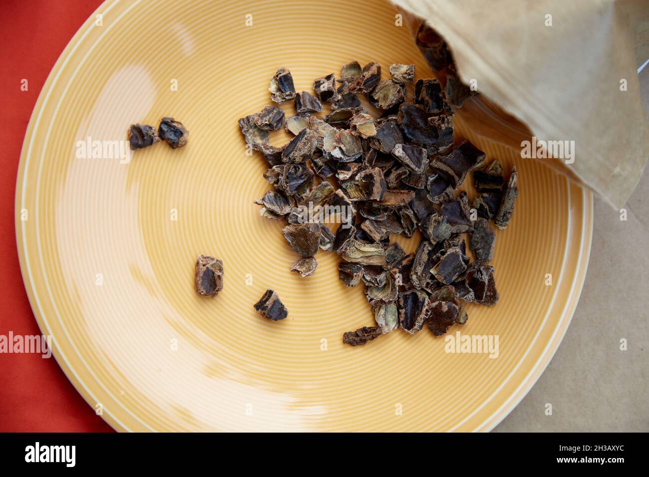 Carob - plant-based caffeine alternative - natural product on the plate. Organic antioxidants. Top view, copy space. High quality photo Stock Photo