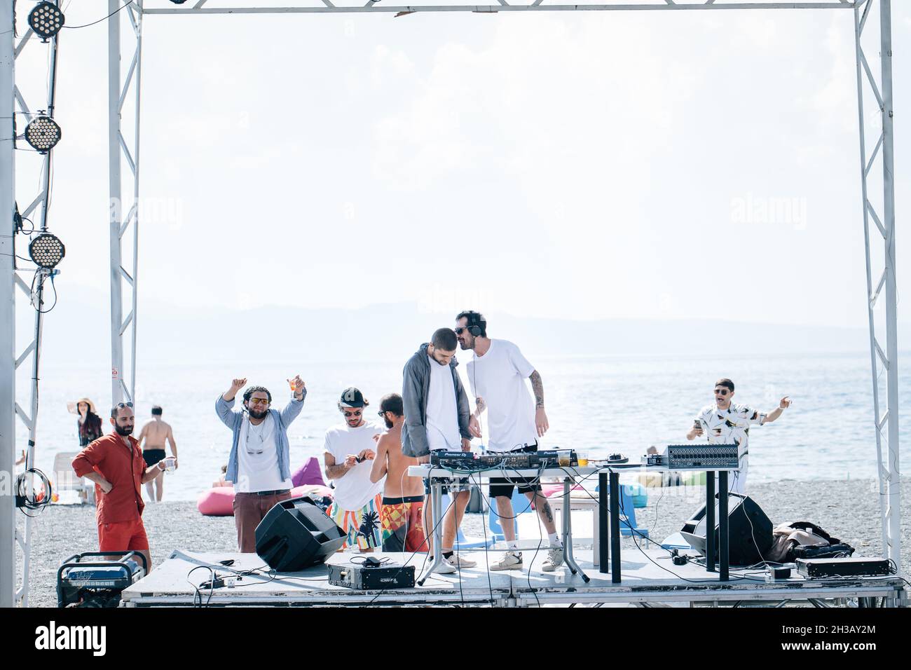 SEVAN, ARMENIA - Sep 03, 2021: A group of young people enjoying the beach party on the shore of Lake Sevan, Armenia Stock Photo