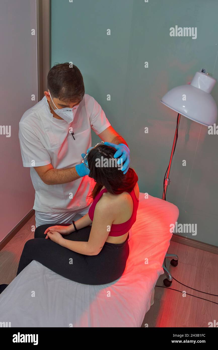 Physician working on examining a girl's injured neck Stock Photo