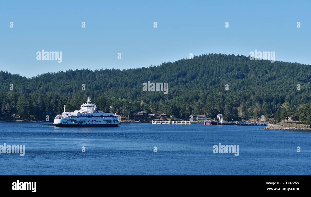 View of BC Ferries vessel Salish Orca leaving Sturdies Bay ferry terminal at Galiano Island, part of the Gulf Islands, on sunny day. Stock Photo