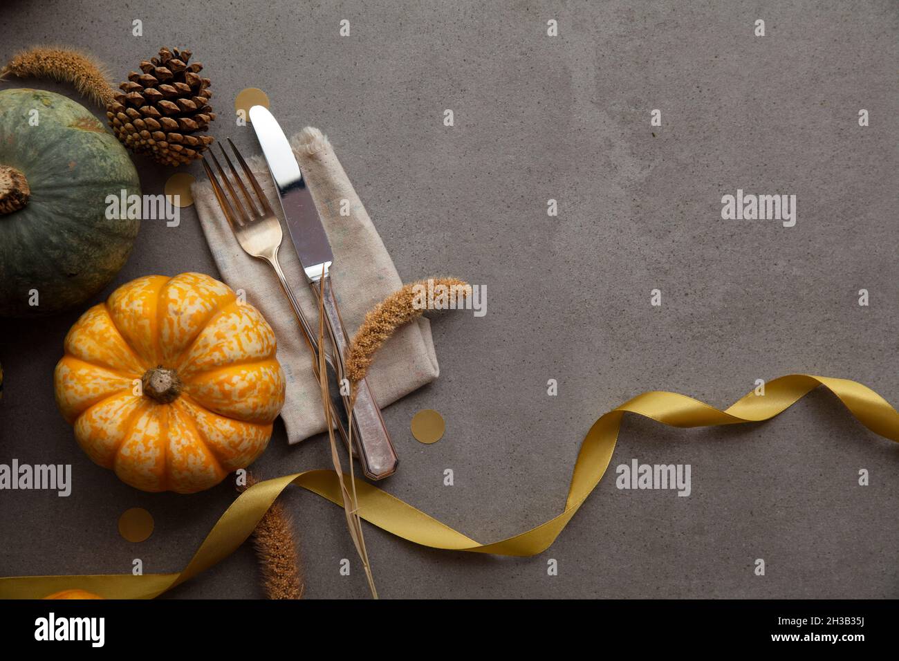 Autumn place setting lifestyle thanksgiving background with cutlery and pumpkins Stock Photo