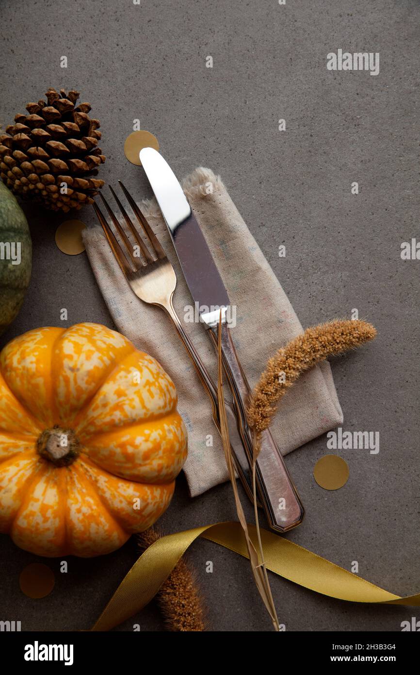 Autumn place setting lifestyle thanksgiving background with cutlery and pumpkins Stock Photo
