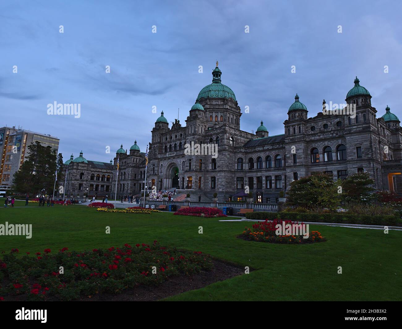 View of historic British Columbia Parliament Buildings, home to the Legislative Assembly of British Columbia, in the evening with cloudy sky. Stock Photo