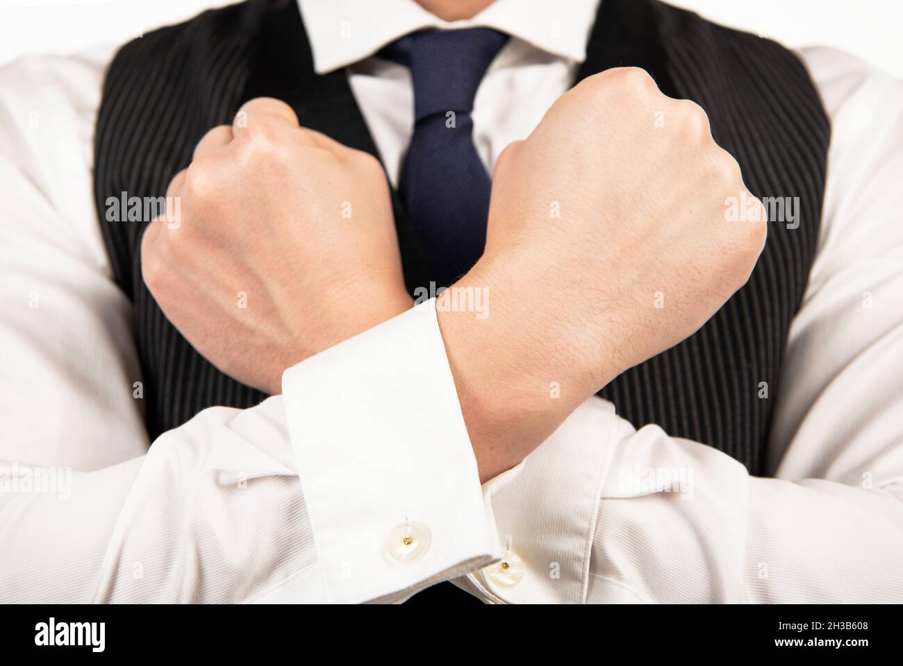man with crossed arms. male confidence. mens beauty. guy holding fists defending himself Stock Photo