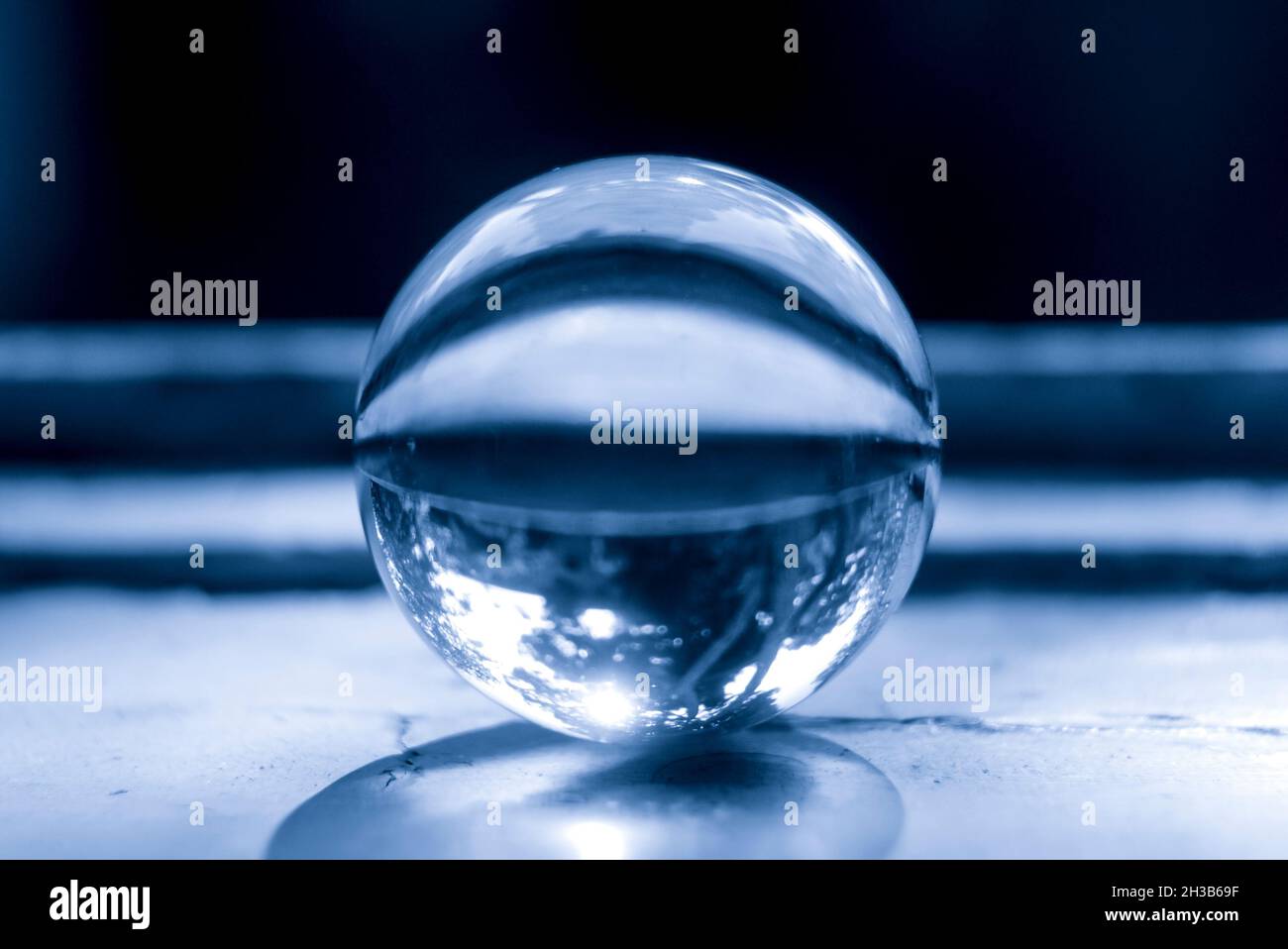 Monochrome image of a lens ball on an old window sill Stock Photo