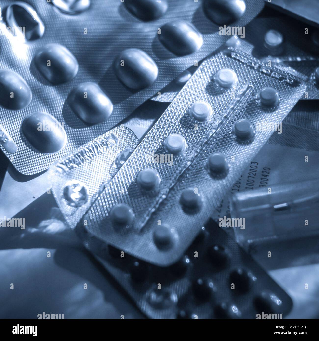 Blue monochrome image of blister packs. Drugs in blue monochrome. Stock Photo