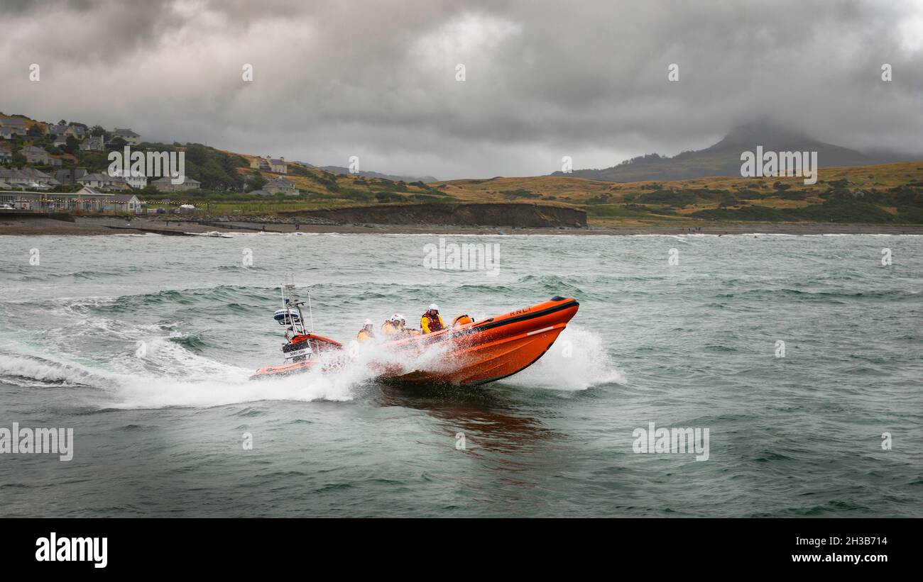 RNLI Criccieth Lifeboat Station's Atlantic 85 class lifeboat powering through the waves. Stock Photo