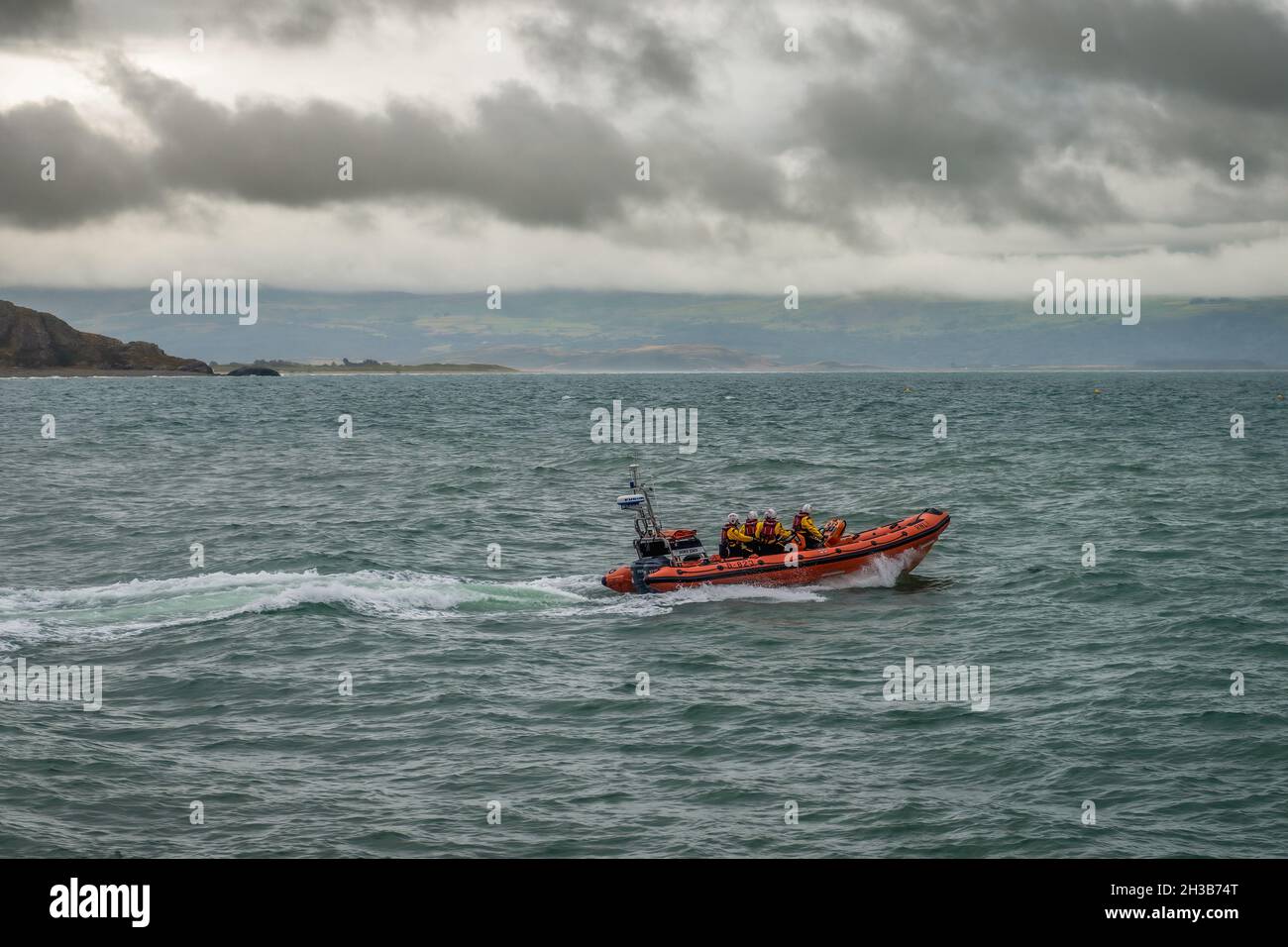 RNLI Criccieth Lifeboat Station's Atlantic 85 class lifeboat heading out to sea. Stock Photo