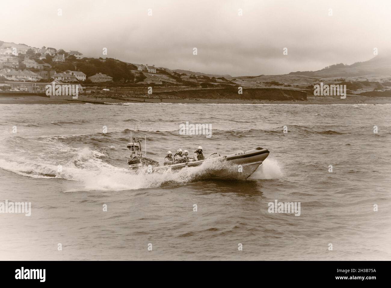 RNLI Criccieth Lifeboat Station's Atlantic 85 class lifeboat battling through the waves. Stock Photo