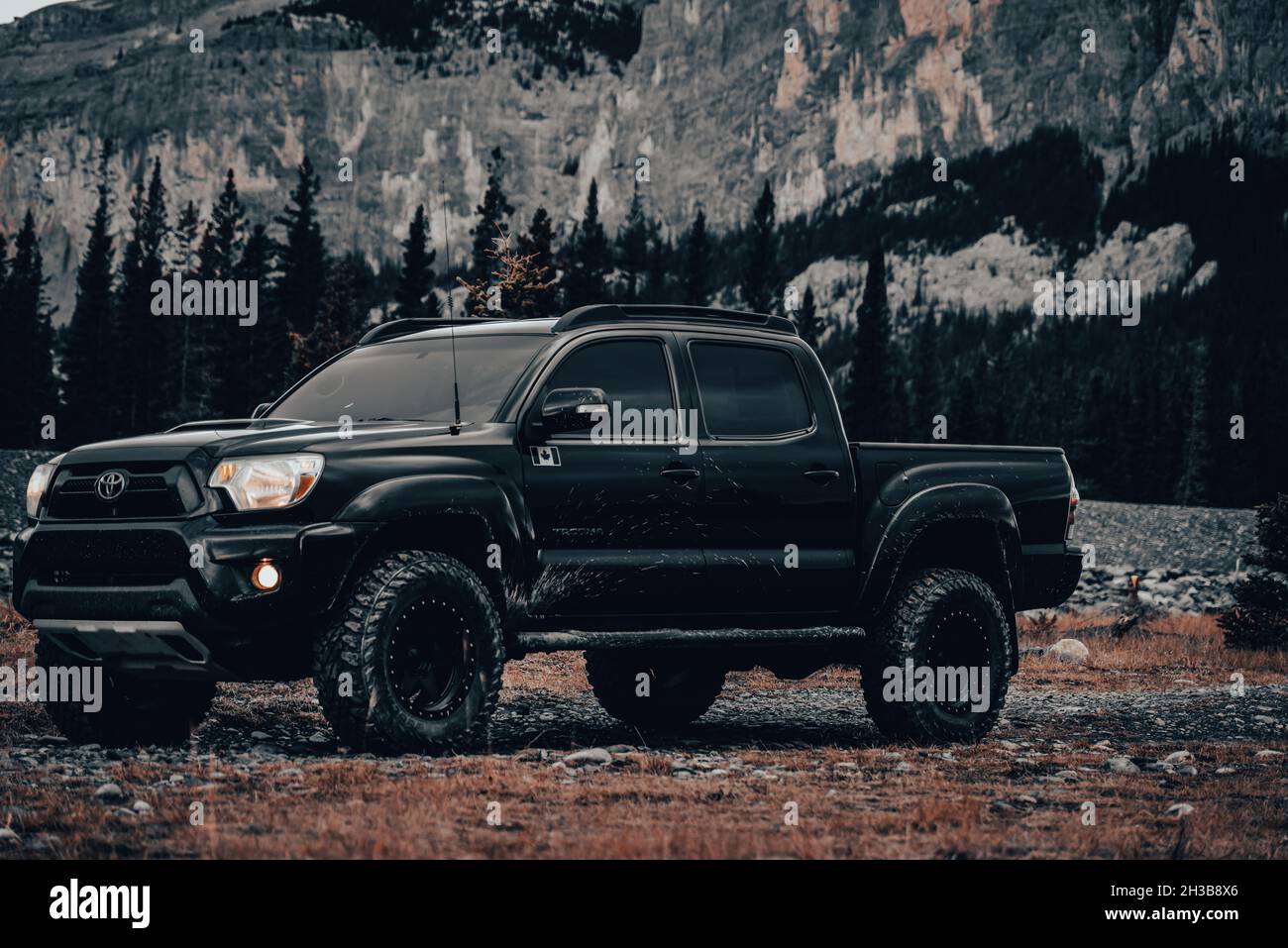 WAIPRUS, CANADA - Oct 25, 2021: Black Toyota Tacoma with mountains and forestry in the background. Stock Photo