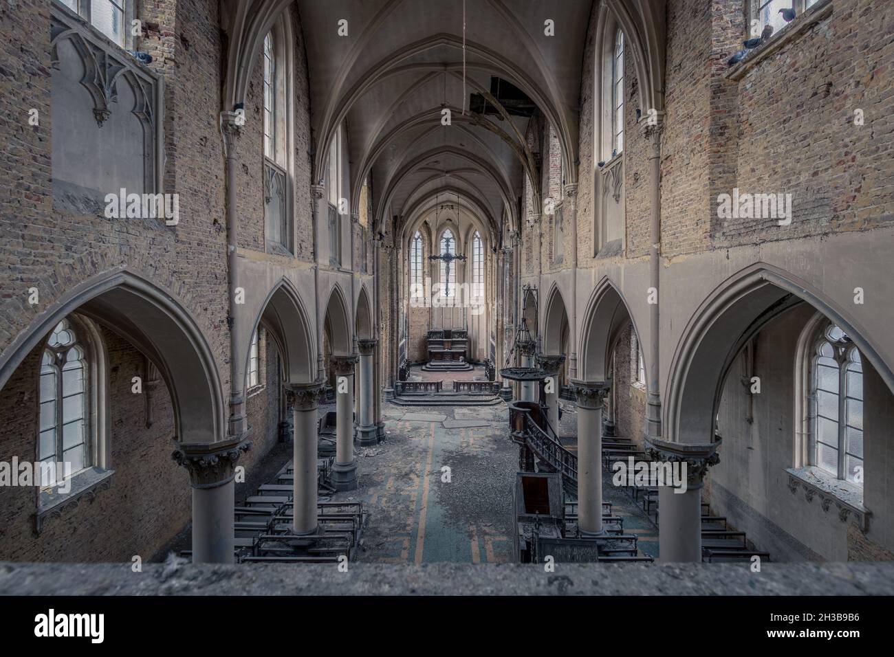 LUETTICH, BELGIUM - Feb 01, 2020: Photograph of an old abandoned church in Belgium. The light shines beautifully through the old windows. Stock Photo