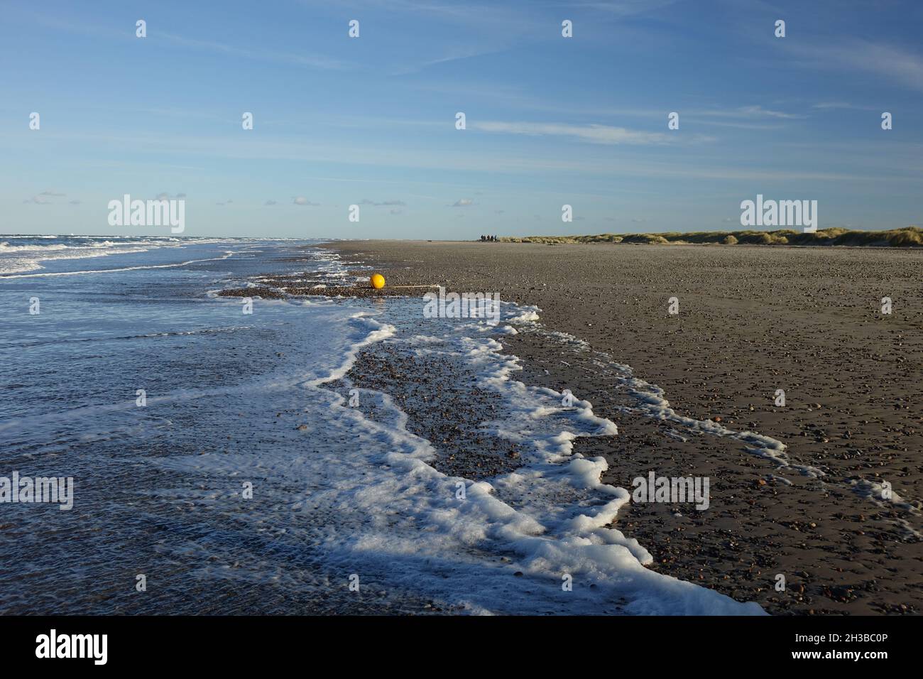 Skagen Nordstrand facing east with shiny orange plastic float near Cape Grenen, meeting point of Skagerrak and Kattegat. Stock Photo