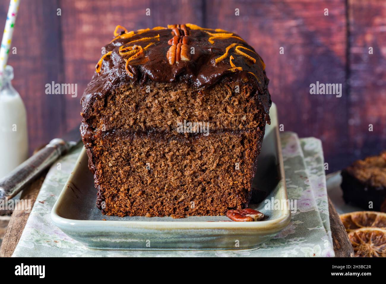 Homemade ginger loaf cake with plum marmalade, pecan nuts and chocolate