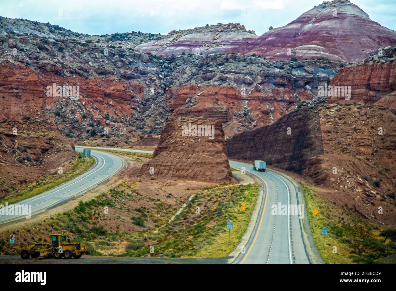 Badlands in Nevada United States with two hunks cut from mountain to make divided highway Stock Photo