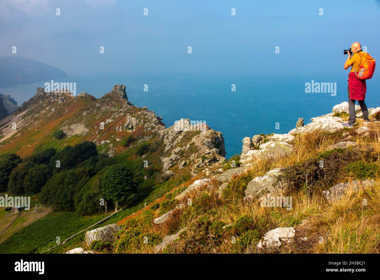 Landscape photographer taking pictures of The Valley of Rocks near Lynmouth in Exmoor National Park North Devon England UK Stock Photo