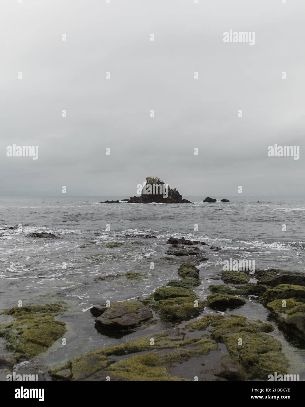 Scenic view of a rocky coast under a gloomy sky Stock Photo - Alamy