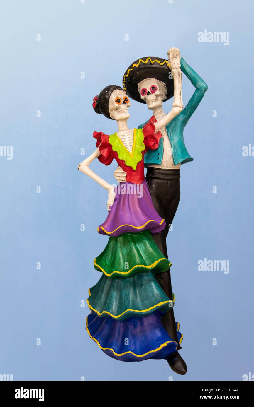 Dancing dia la Muertos couple - Ceramic decoration - against blue gradient background. Stock Photo
