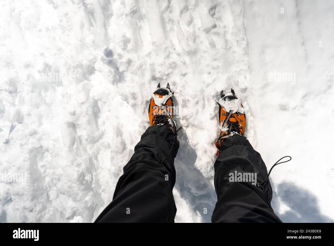 Snow crampones on a orange shoes Stock Photo