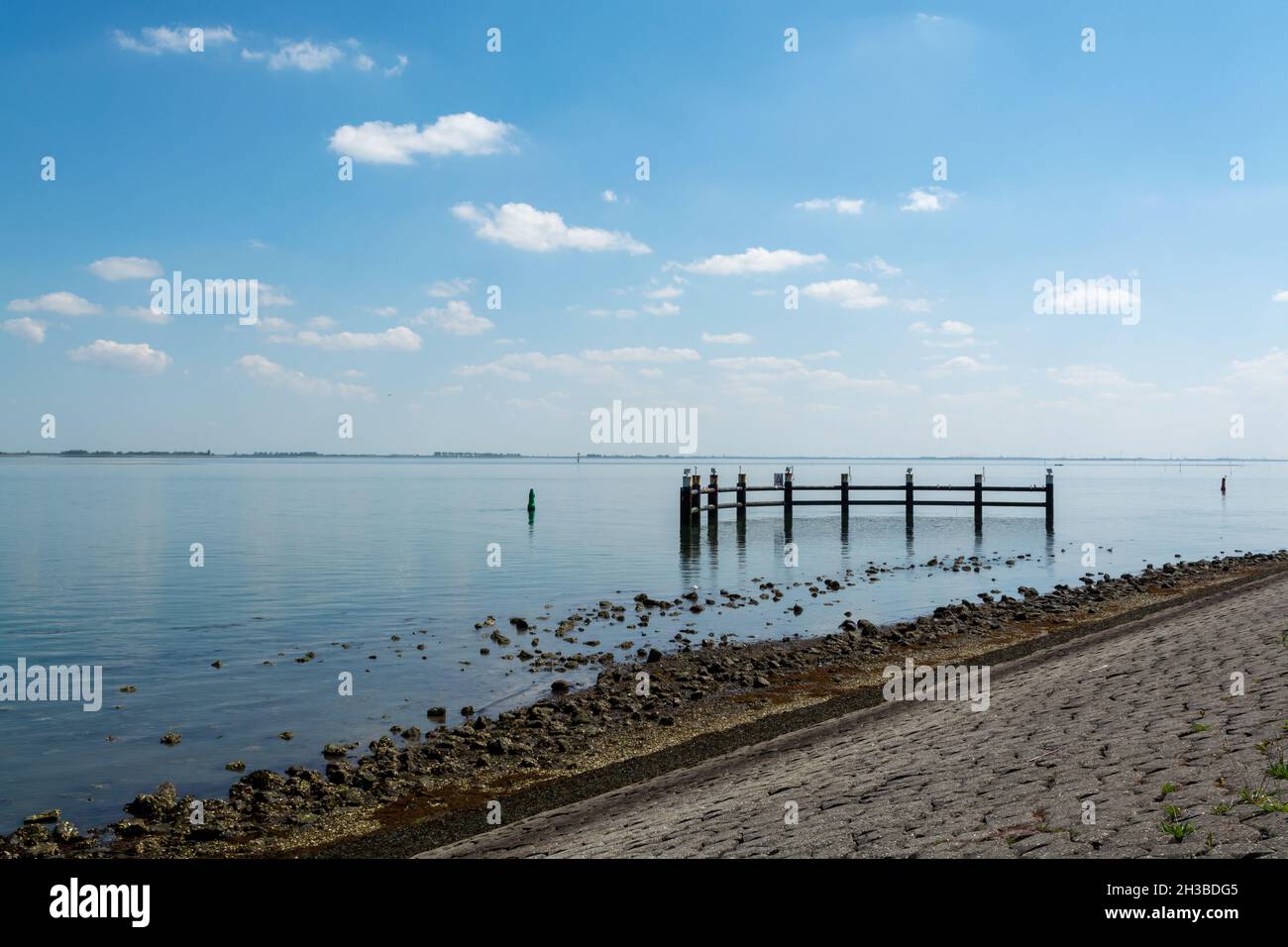 Walking along shoreline and beaches of Oesterschelde near Yerseke at
