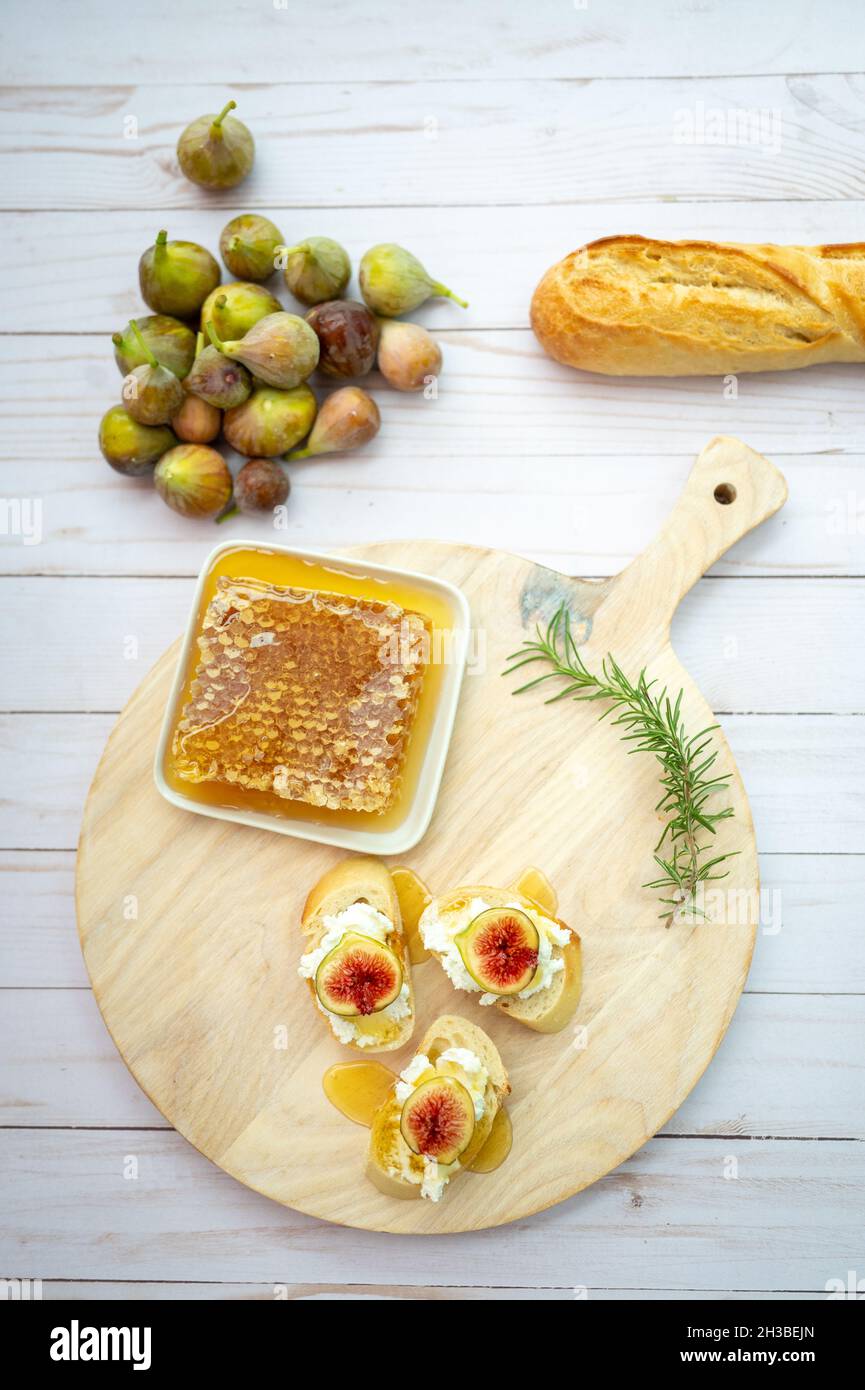 Bright and airy charcuterie board with honey comb and figs Stock Photo