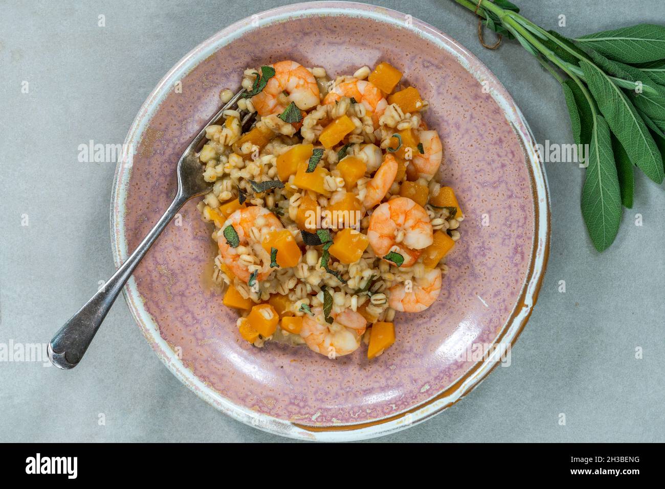 Pearl barley risotto with king prawns, butternut squash and sage overhead view Stock Photo Alamy