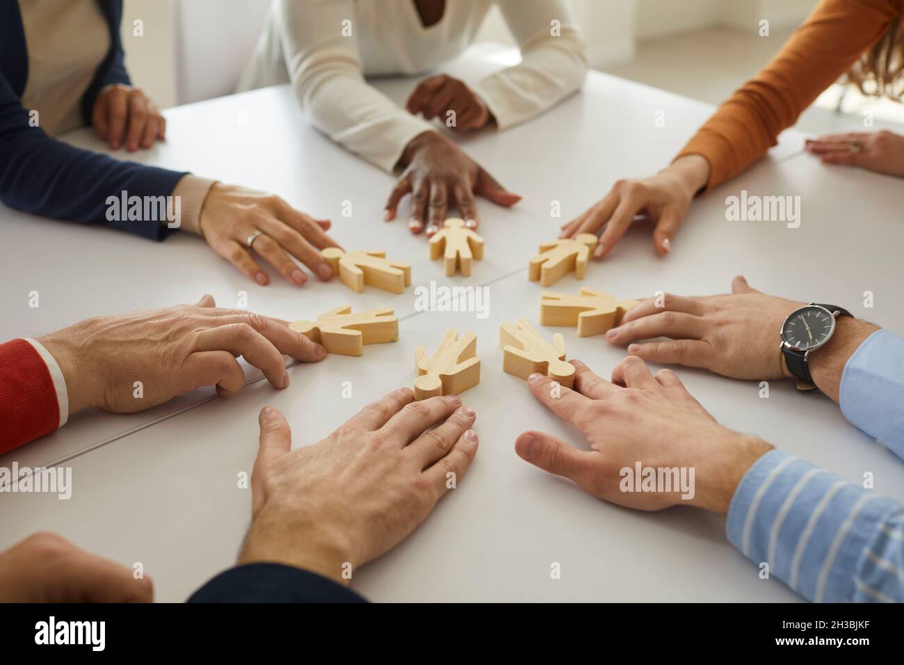 Group of business people join little human figures as symbol of community and teamwork Stock Photo
