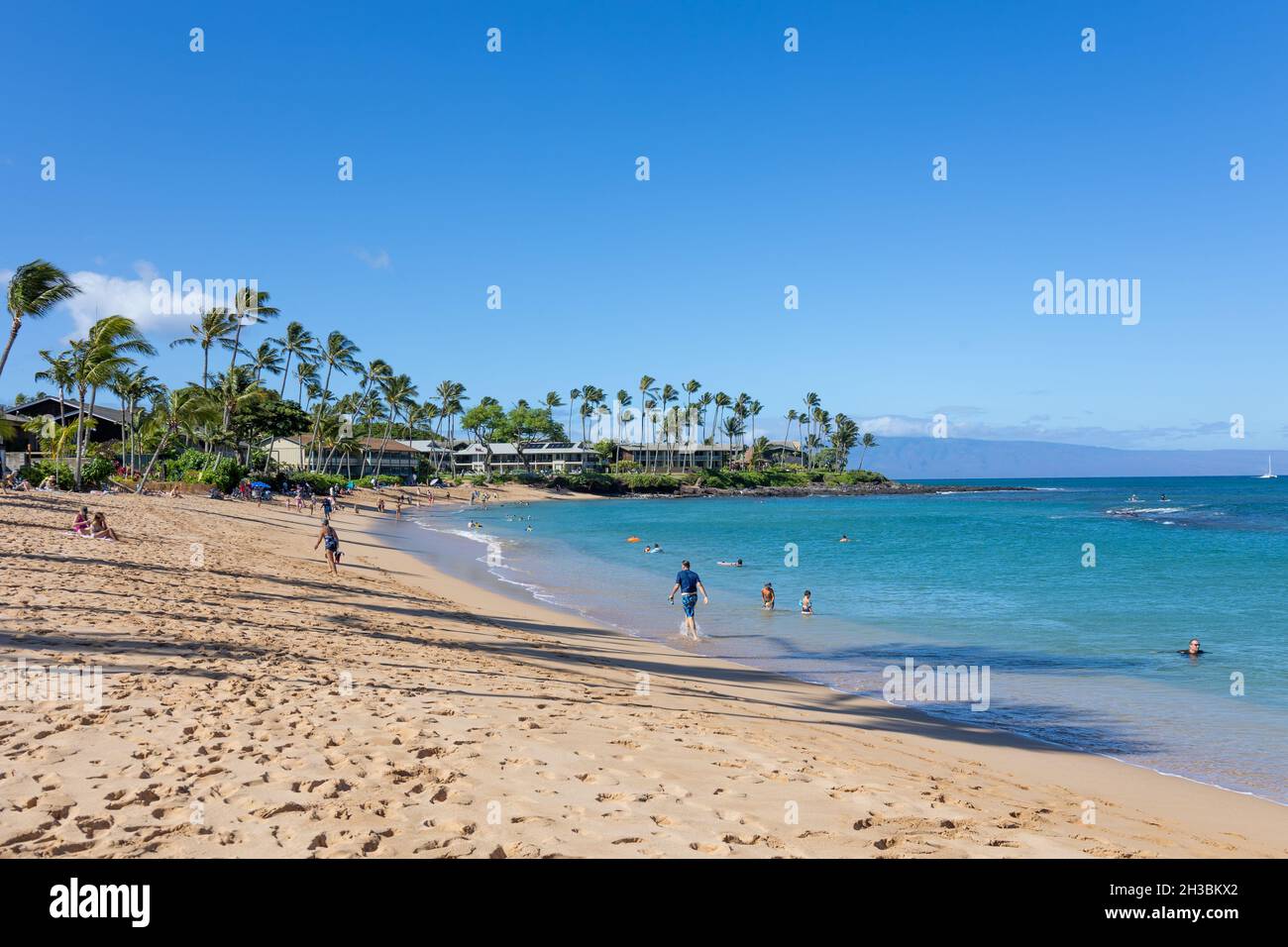 Tourist enjoying tropical beach with white sand and crystal clear water