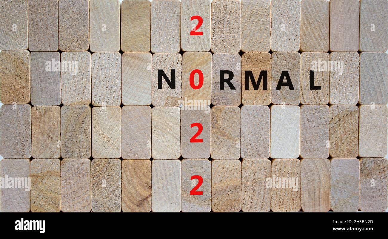 Symbol of covid-19 normal in 2022. Wooden blocks with words 'normal 2022'. Beautiful wooden background, copy space. Medical, covid-19 normal in 2022 c Stock Photo