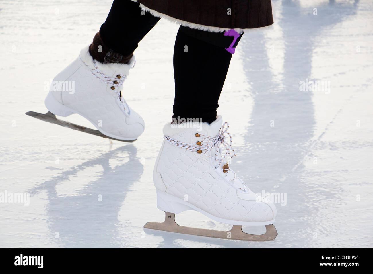 winter recreation, ice skating on the rink, ice skating with reflection. close-up Stock Photo
