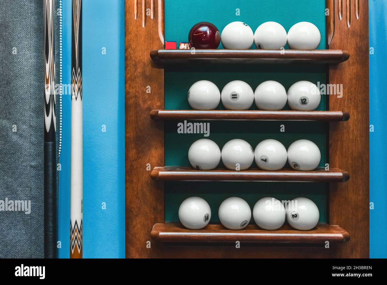 Shelf with white balls and billiards equipment. Stock Photo