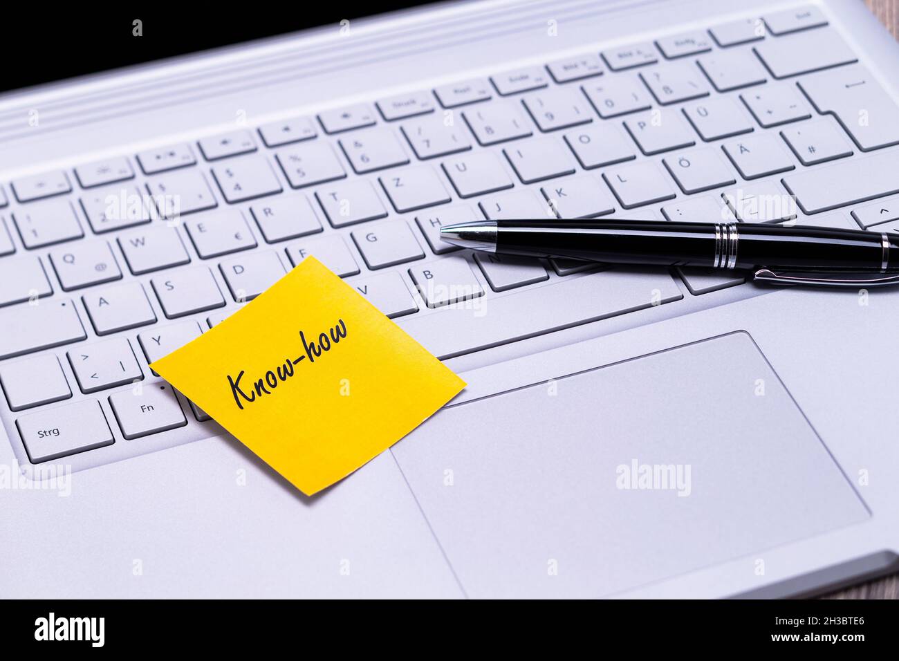 The photo shows a note with the text know how on a notebook computer Stock Photo