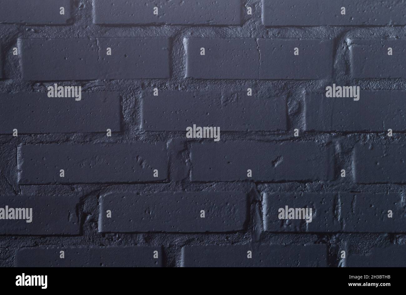 The photo shows a black clinker wall that can be used as a background Stock Photo