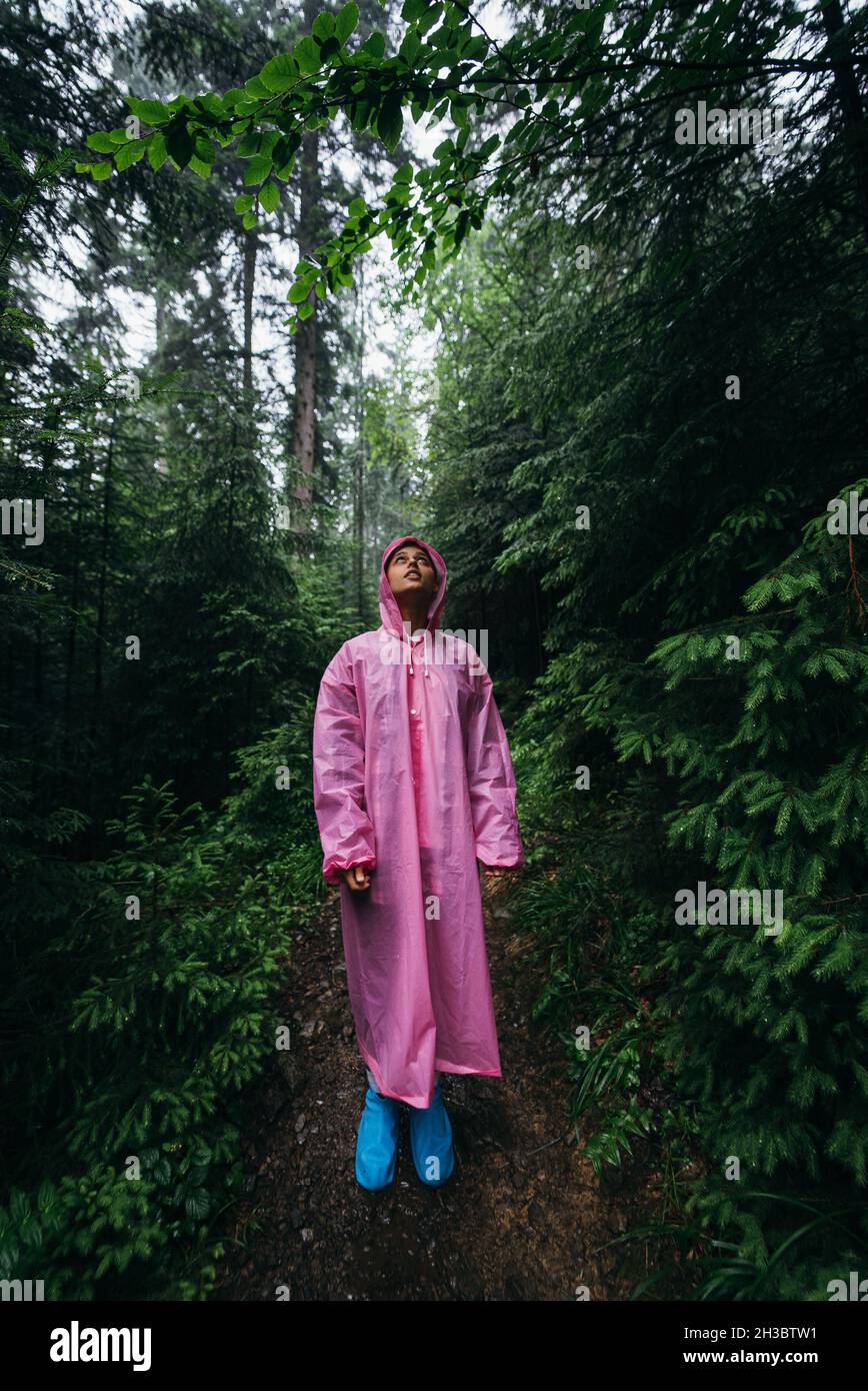 Woman in raincoat walks through hi-res stock photography and images - Alamy