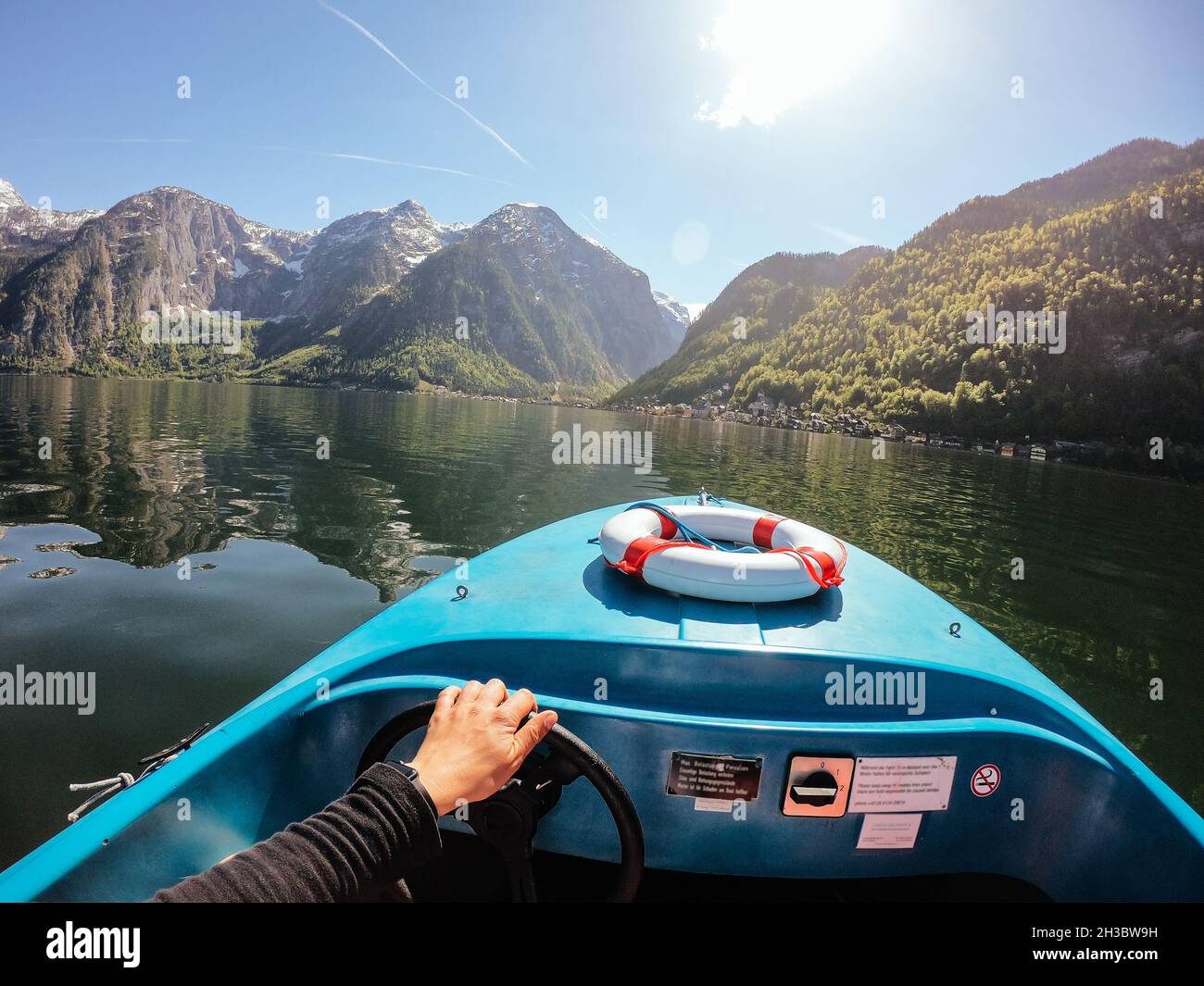 Man controls a motorboat on a mountain lake Stock Photo - Alamy