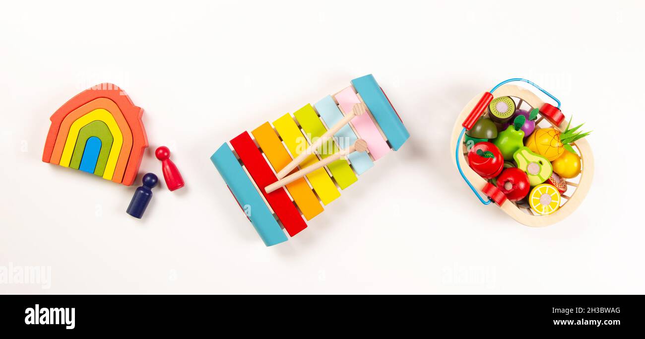 Baby kids toys. Top view to colorful educational wooden toys arranged on  white background. Early education for kids. Learning music for children  Stock Photo - Alamy