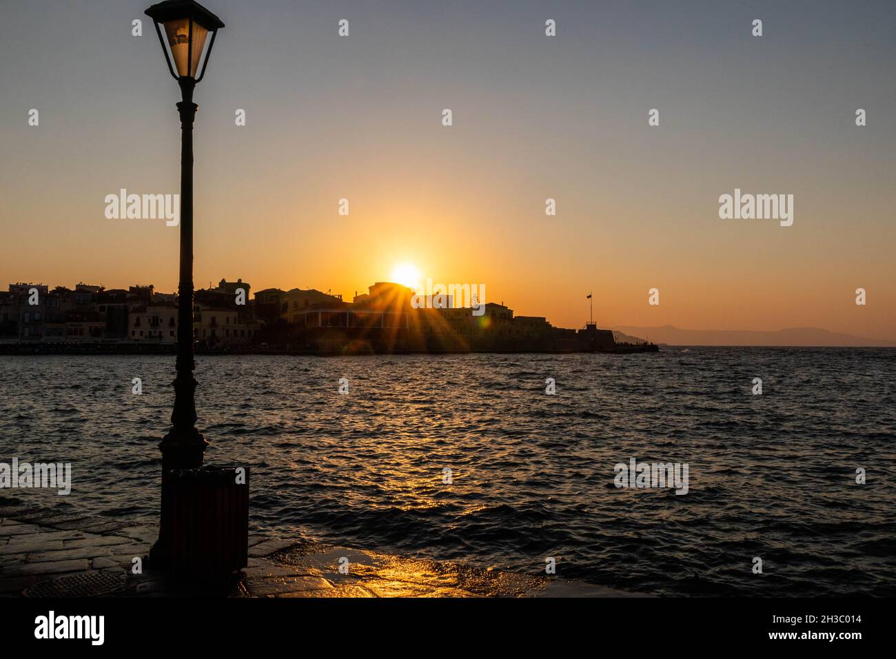 Sun setting over the Venetian Harbour, Chania, Crete, Greece Stock Photo