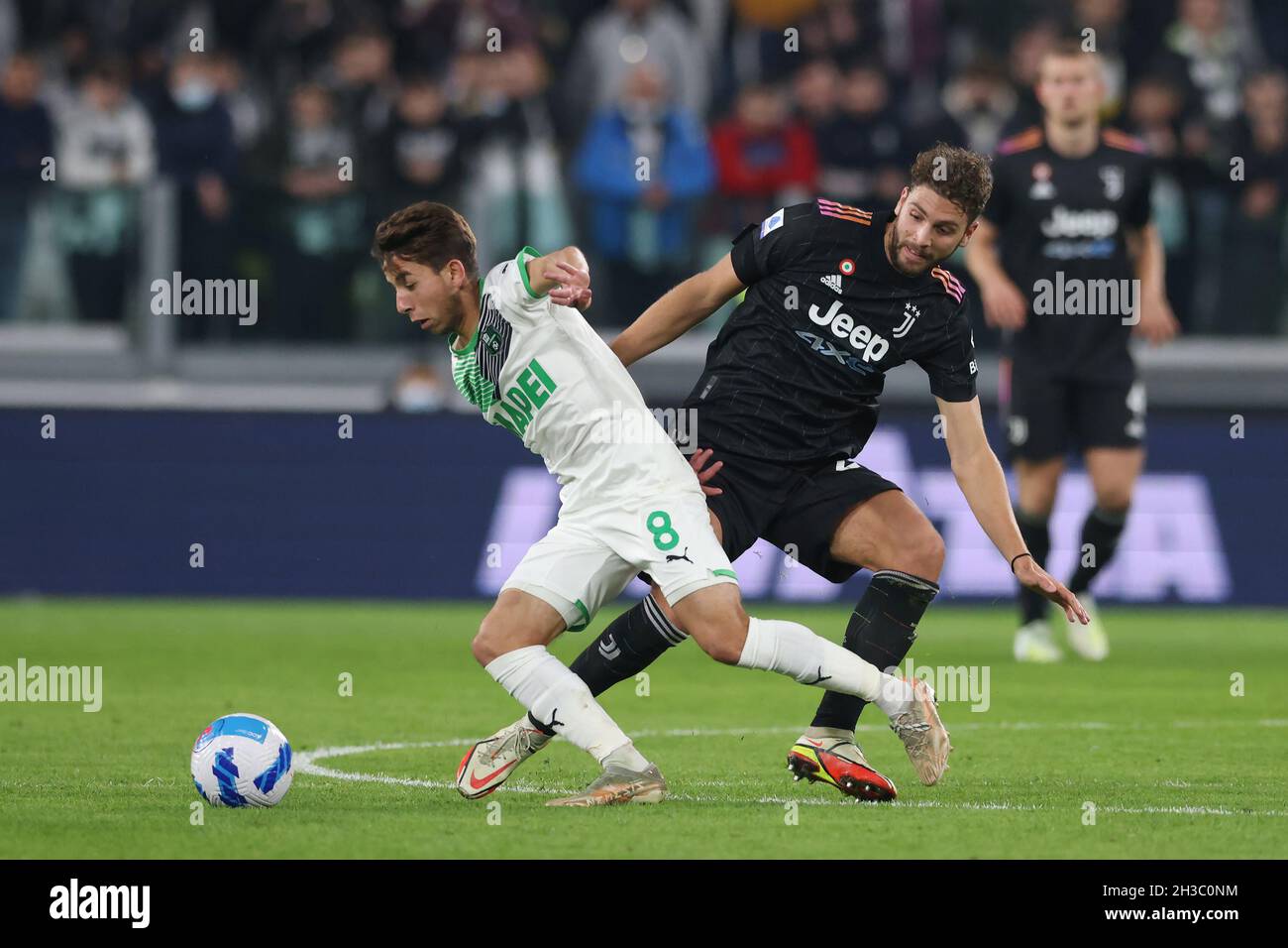 Turin, Italy, 27th October 2021. Maxime Lopez of US Sassuolo is upended by Manuel Locatelli of Juventus during the Serie A match at Allianz Stadium, Turin. Picture credit should read: Jonathan Moscrop / Sportimage Stock Photo
