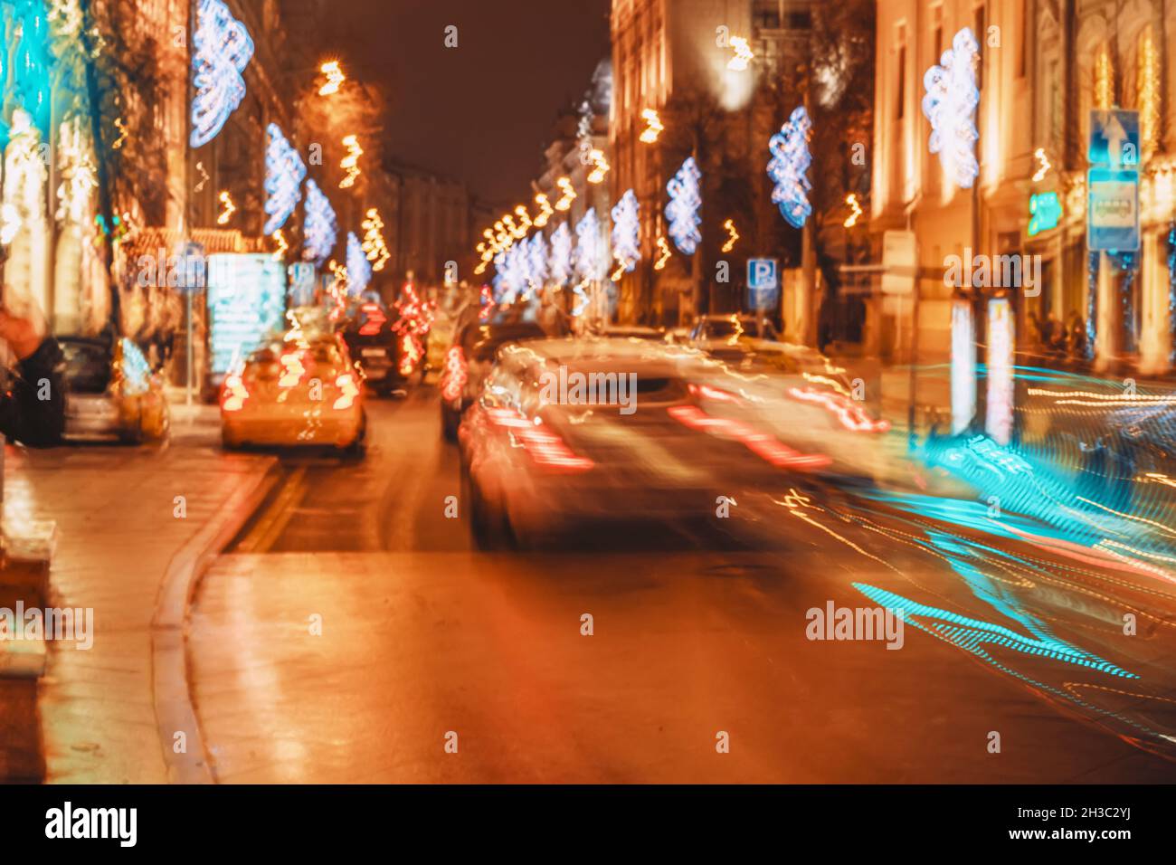 City traffic at night, auto with bright brake lights, city street neon