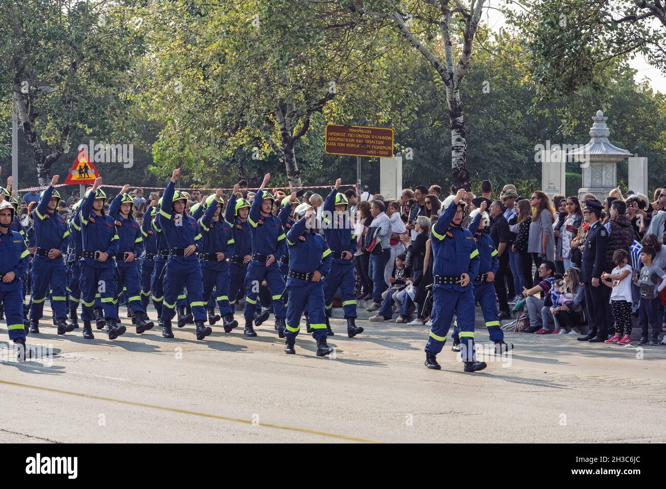 Thessaloniki, Greece - October 28 2019: Greek Fire Service personell during Oxi Day parade. Hellenic Fire Brigade firefighters in blue uniform and helmets at national day celebration parade. Stock Photo