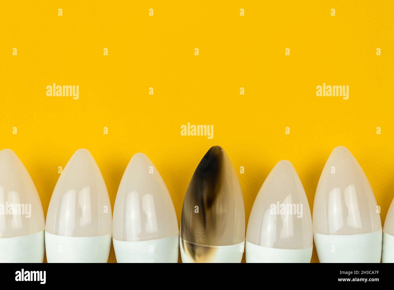 Broken and burned LED light bulb after fire, home safety concept